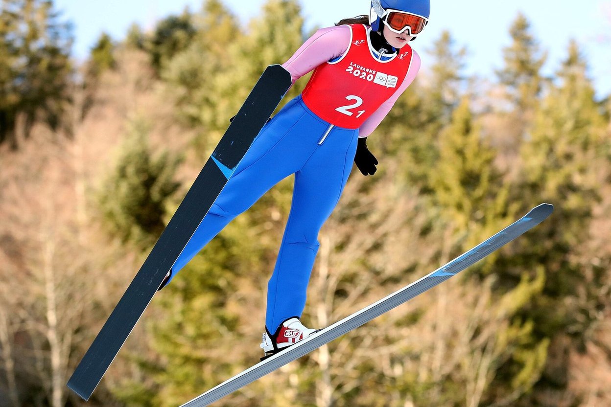 A ski jumper in the V position in flight during a competition