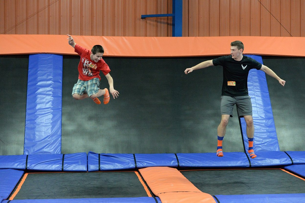 Kids jumping at an indoor trampoline park with padded edges