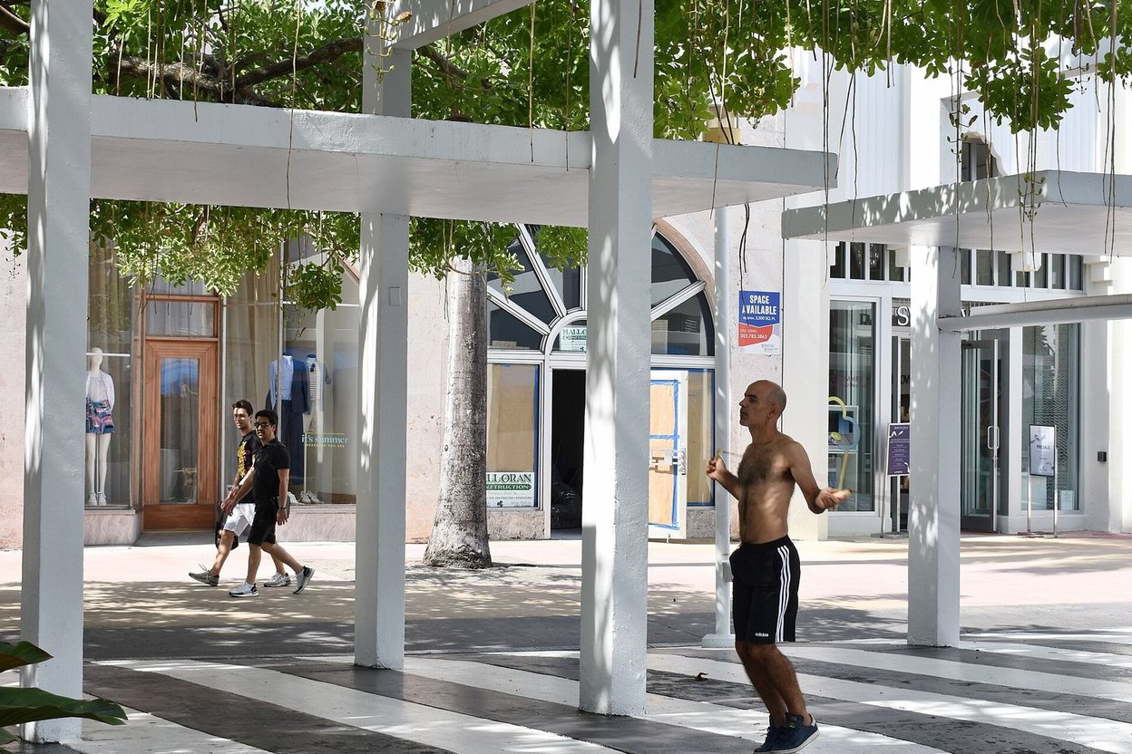 A man jumping rope on an outdoor plaza