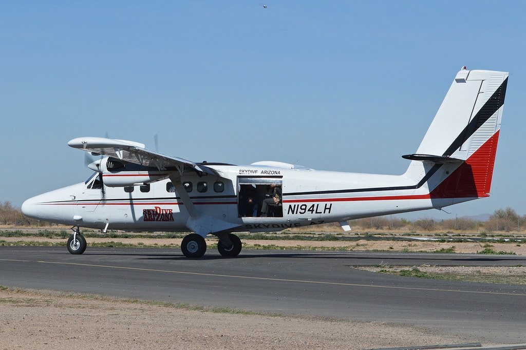 White Skydive Arizona plane on runway with red and black tail