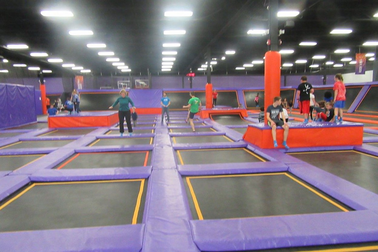 People checking in at a trampoline park front desk